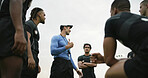 Rugby, team and conversation outdoor with coach, explain strategy or advice for tournament practice. Low angle, sports manager and people with game plan, tactical discussion or instructions for match