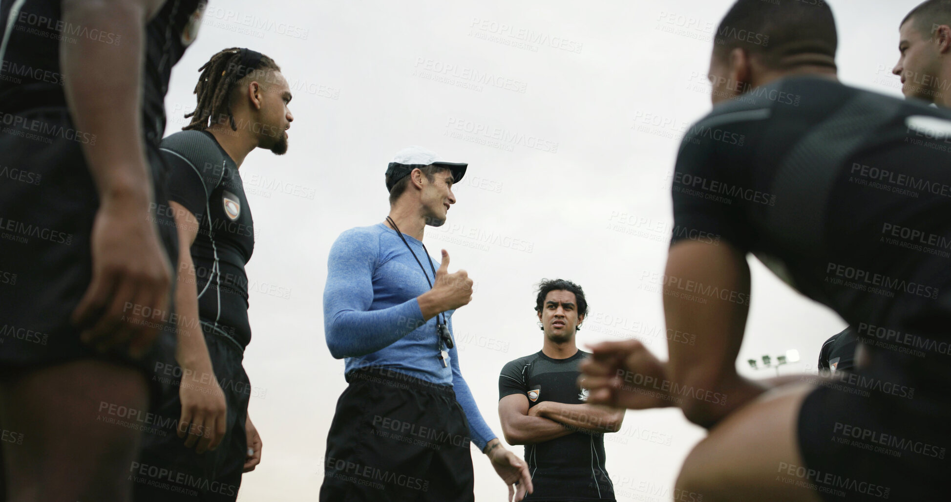 Buy stock photo Rugby, team and conversation outdoor with coach, explain strategy or advice for tournament practice. Low angle, sports manager and people with game plan, tactical discussion or instructions for match
