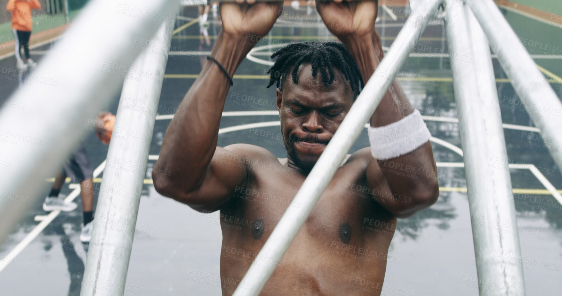 Buy stock photo Athlete, man and play game on basketball court with fitness, practice skills and hang from structure. Active, black person and sports match outdoor with strength, exercise and workout for wellness.