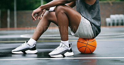 Buy stock photo Man, legs and sneakers with basketball on court for outdoor game, match or sports practice. Male person, athlete or player rest on ball for training break, competition or exercise on urban pitch