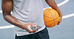 Man, hands and typing at basketball court with phone, fitness app or search training tips for practice. Athlete, person outdoor and scroll with tech for social media, text message and sports website.