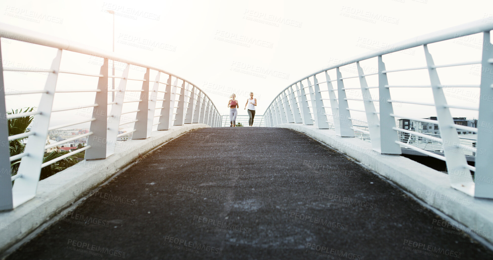 Buy stock photo Bridge, fitness and running with women in city together for cardio, training or workout. Breathing, pace and space with runner friends outdoor in urban town for health, physical activity or wellness