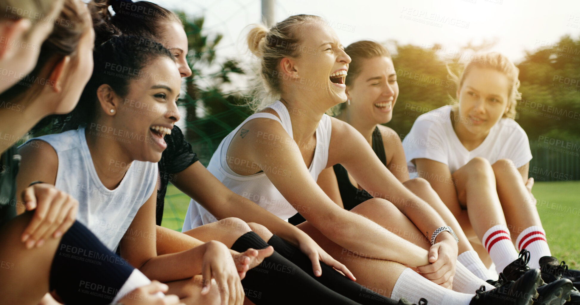 Buy stock photo Fitness, relax and team with laughing on field, soccer joke and bonding for sports training break. Football practice, friends and happy women with funny conversation for connection, humor and resting