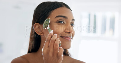 Buy stock photo Smile, skincare or woman with jade roller at bathroom, lymphatic drainage or beauty with glow. Home, happy person or tool for facial massage for health, circulation or dermatology benefits in morning
