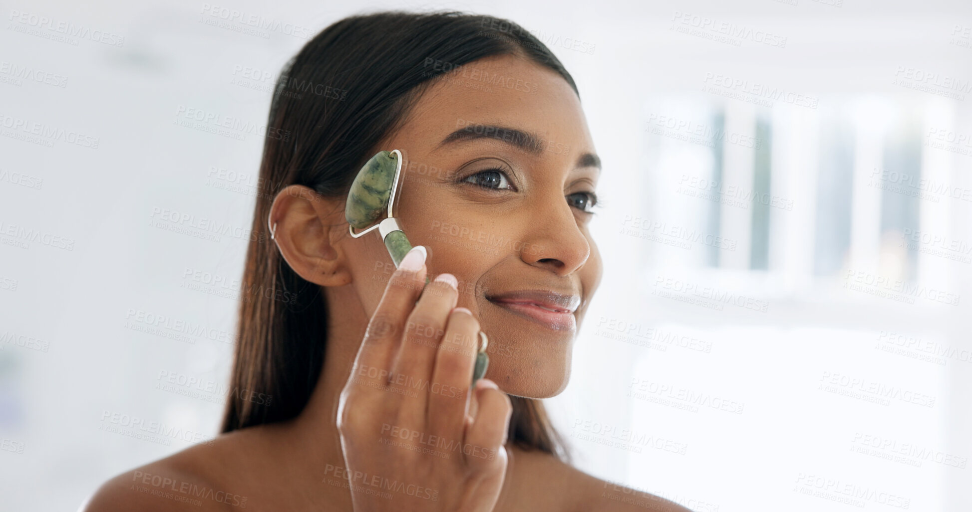 Buy stock photo Smile, skincare or woman with jade roller at bathroom, lymphatic drainage or beauty with glow. Home, happy person or tool for facial massage for health, circulation or dermatology benefits in morning