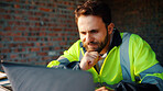 Happy, architect and man with laptop in construction site, research and property development on web. Civil engineer, reading and person with technology for architecture project and quality assurance