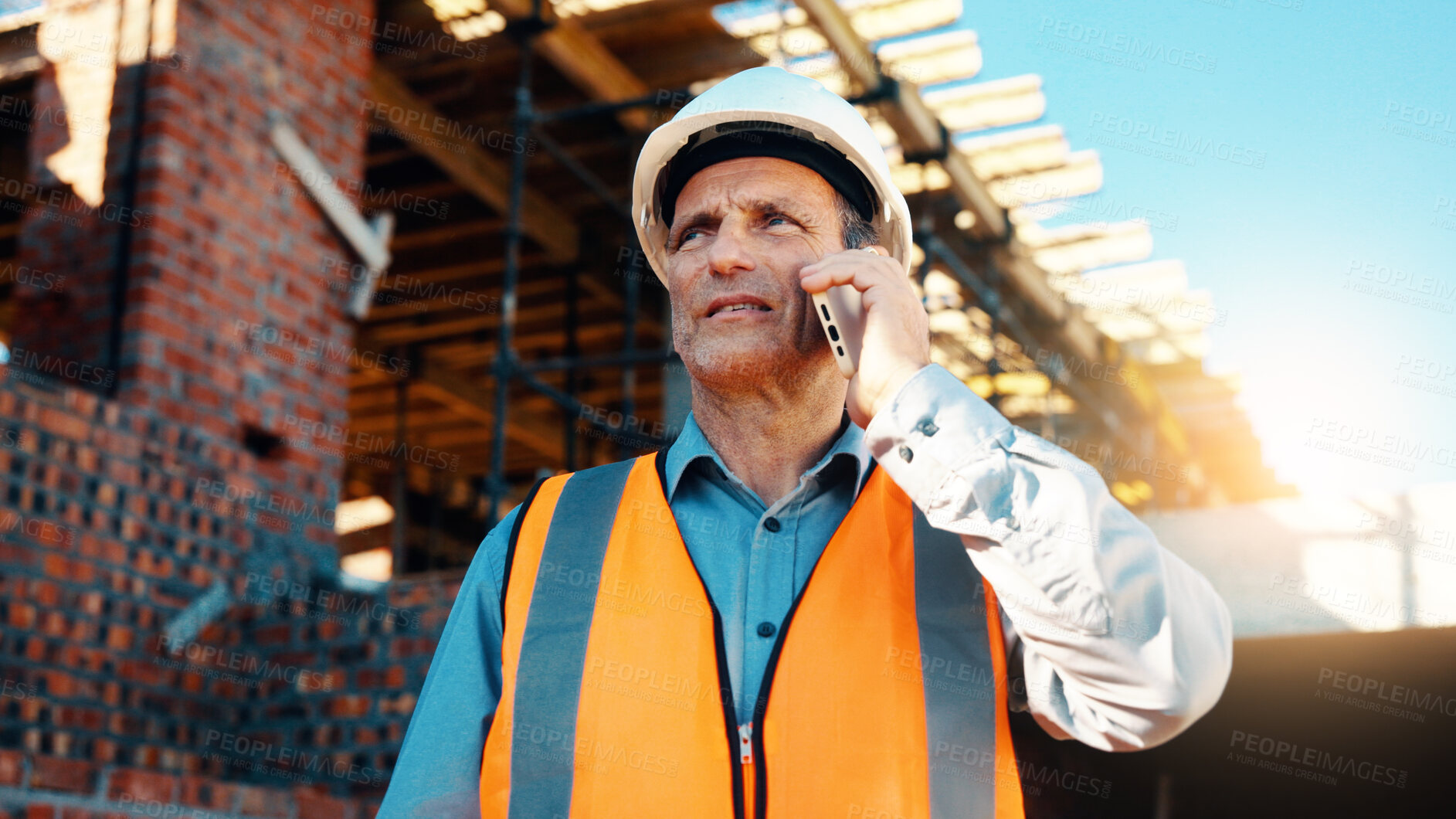 Buy stock photo Architect, talk and man with phone at construction site, communication or safety update for contact. Outdoor, civil engineer and mature person with mobile for discussion, quality assurance and chat