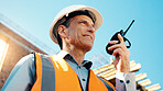 Happy, architect and man with radio at construction site, communication or safety update for contact. Low angle, civil engineer and mature person with tech for discussion, quality assurance and chat