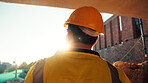 Construction, thinking and man with back on site for building progress, property vision or space. Foreman, person or reflection outdoor for development, quality control or project management on flare