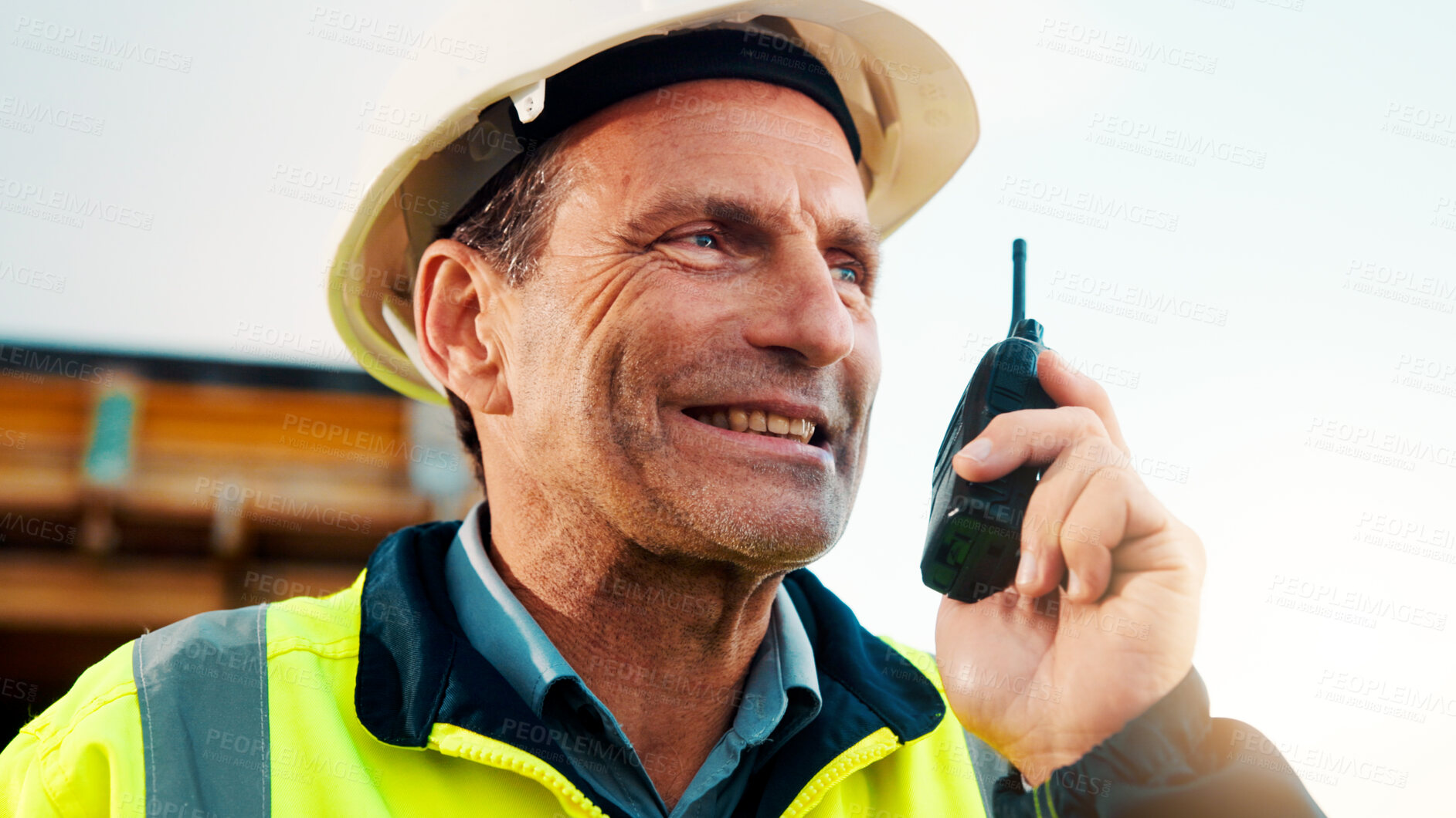 Buy stock photo Man, engineer and talk with radio at construction site for inspection, safety check and property development. Mature person, architect and communication for real estate progress and tech in Canada