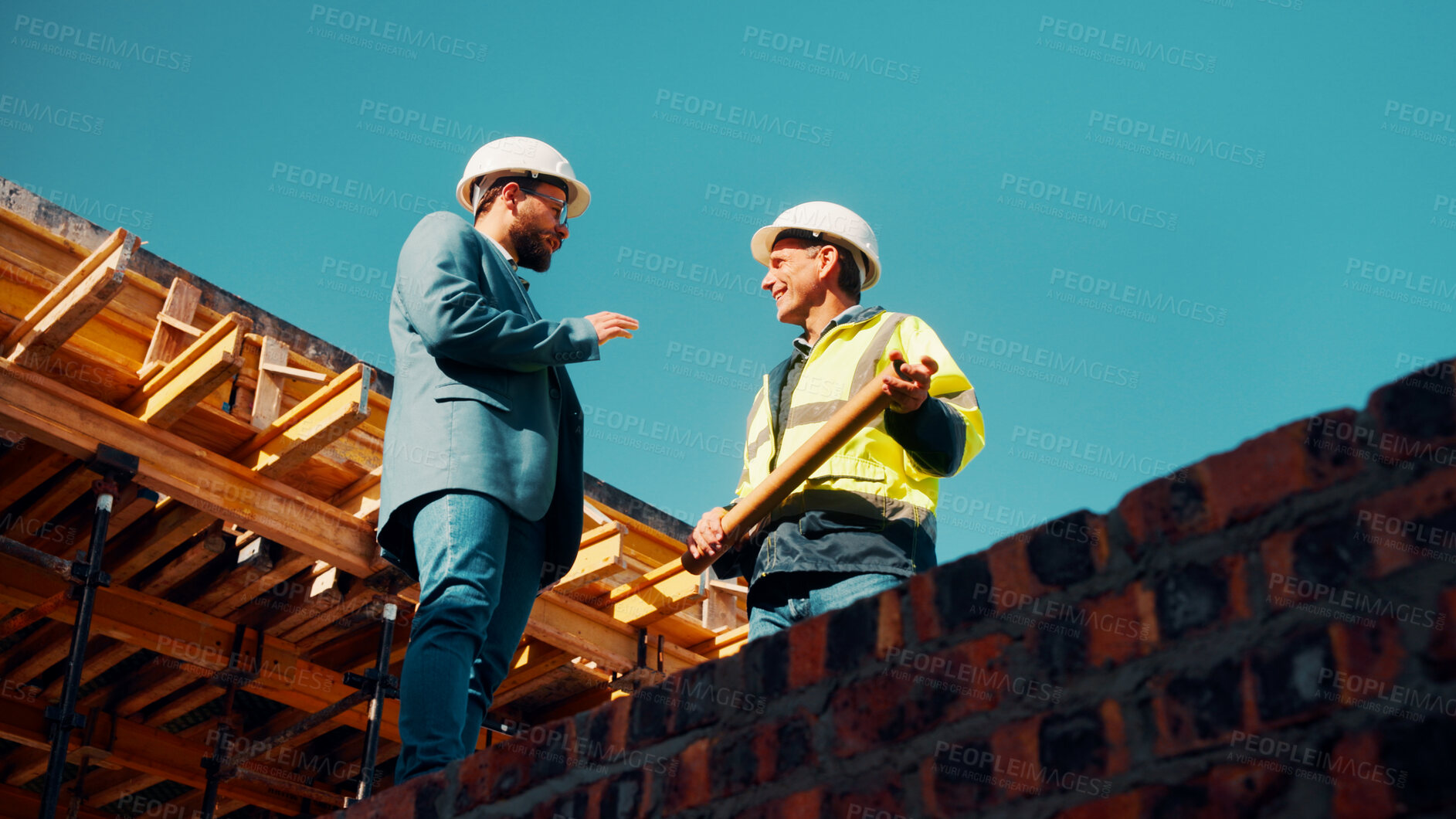 Buy stock photo Talk, architect or manager with blueprint for construction design, building update or teamwork. Low angle, men or project foreman with floor plan on roof for progress, quality control or architecture