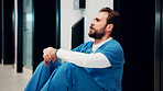 Stress, doctor and man on floor in hospital with burnout for mistake, surgery fail and patient loss. Healthcare, thinking and person with worry, guilt and reflection for crisis in medical service