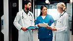Meeting, hallway and doctors with paperwork in hospital for planning, surgery schedule and diagnosis. Healthcare, clinic and people with notes for consulting, treatment and medical service with team