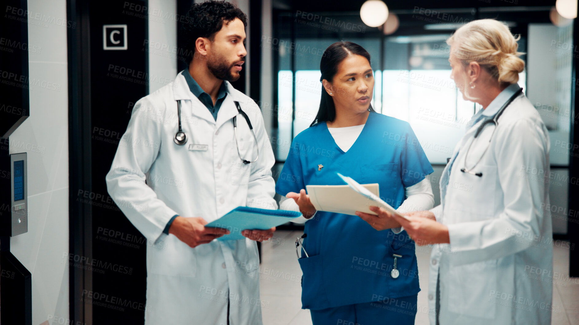 Buy stock photo Meeting, hallway and doctors with paperwork in hospital for planning, surgery schedule and diagnosis. Healthcare, clinic and people with notes for consulting, treatment and medical service with team