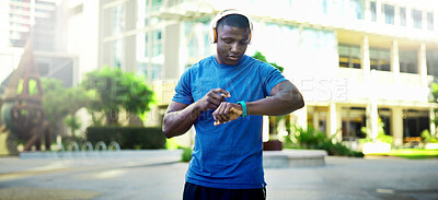 Buy stock photo Fitness, man and headphones with smart watch in city to start cardio, monitor workout and playlist. Athlete, black person and set pace timer outdoor to track exercise, heart rate and streaming music