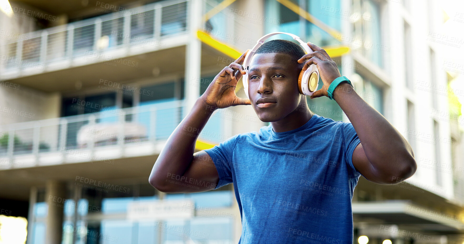 Buy stock photo Serious, athlete and man with headphones in city, wellness and streaming music for physical activity. Outdoor, fitness and black person with tech for audio, thinking or bodybuilder with subscription