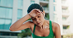 Sweating, fitness and woman in city with break for exercise, cardio or training for wellness. Tired, athlete and female person with rest in urban town for workout, health or active with sports.