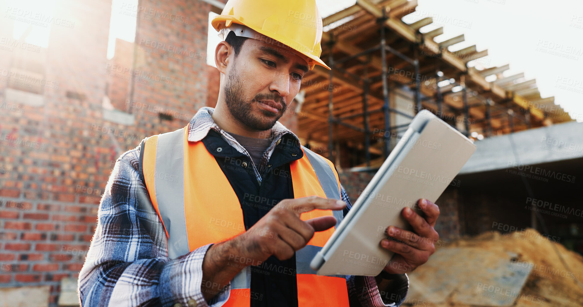 Buy stock photo Civil engineer, online and man with tablet at construction site, scroll or project update on website. Outdoor, architect and person with tech for property development, report and safety inspection