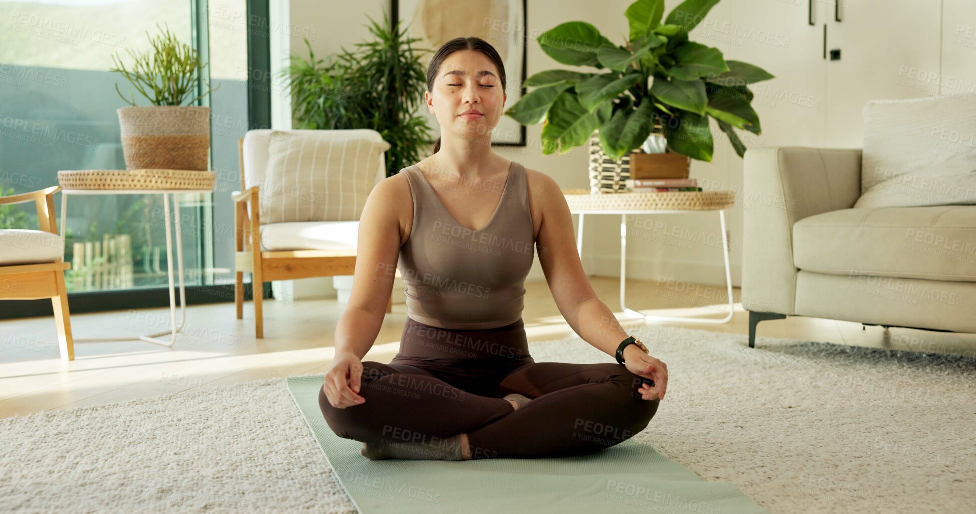 Buy stock photo Yoga, meditation and Asian woman in home in lotus pose for mindfulness, wellness and peace. Morning, apartment and person on mat for breathing exercise, spiritual awareness and reflection on weekend