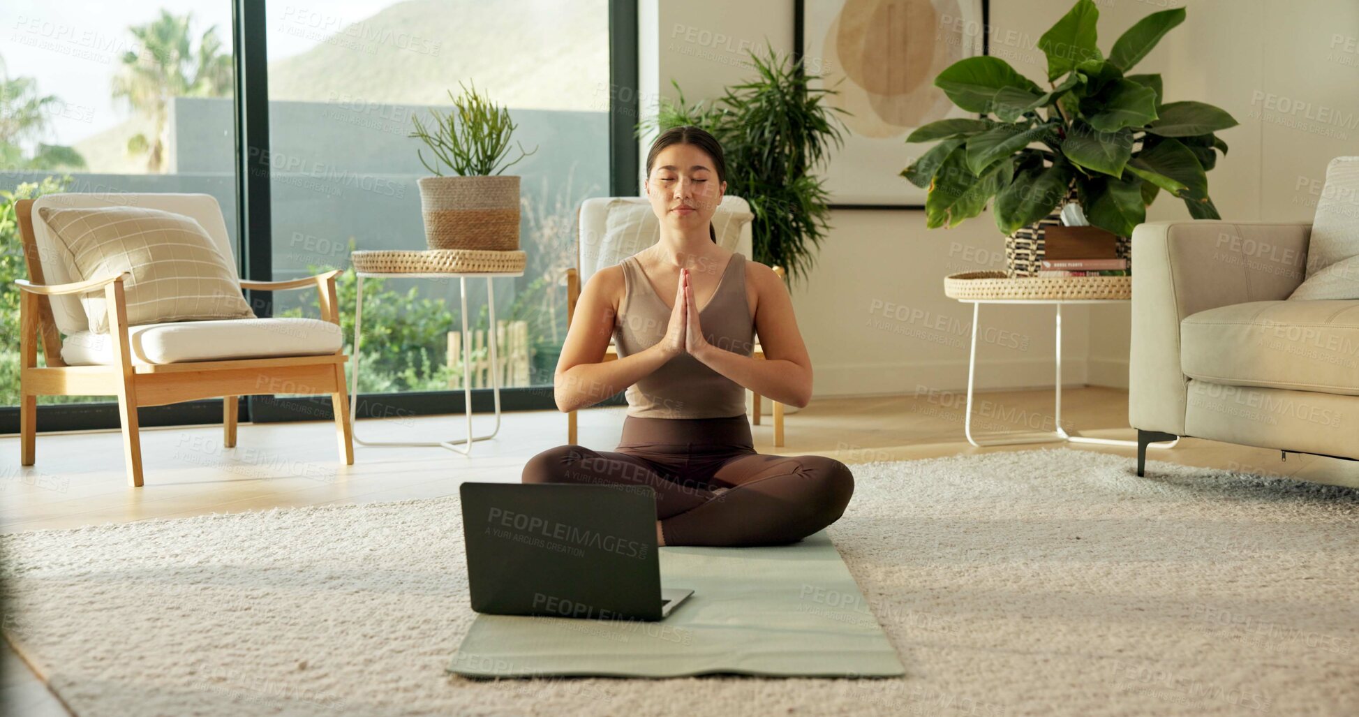 Buy stock photo Laptop, meditation and Asian woman in home with prayer hands for mindfulness, wellness and yoga. Morning, apartment and person on mat for online video for peace, spiritual awareness and reflection