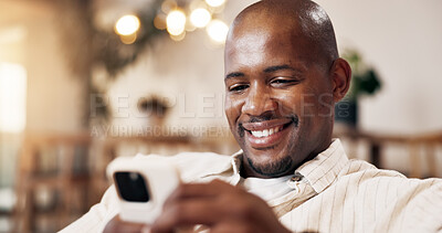 Buy stock photo Relax, home and black man with phone for social media, communication or online conversation. Male person, smile or texting with smartphone for virtual chat, discussion or network connection in house