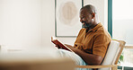 Reading, relax and smile of black man on chair in home living room for fable or fiction. Book, happy and literature story with mature person in apartment for break, fantasy tale or hobby on weekend