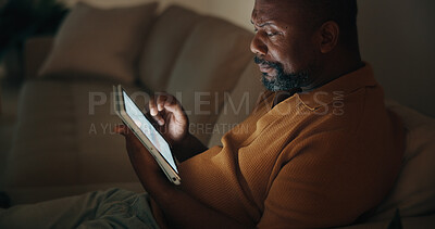 Buy stock photo Night, data analysis or black man in home with tablet screen, forecast or budget report in remote work. WFH, mature person or finance analyst with tech, performance track or stats monitor in dark.