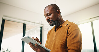 Buy stock photo Creative, black man and writing in home with tablet, remote work and sketch for animation. Mature person, review or freelancer at house with digital, editing cartoon or graphic design for project