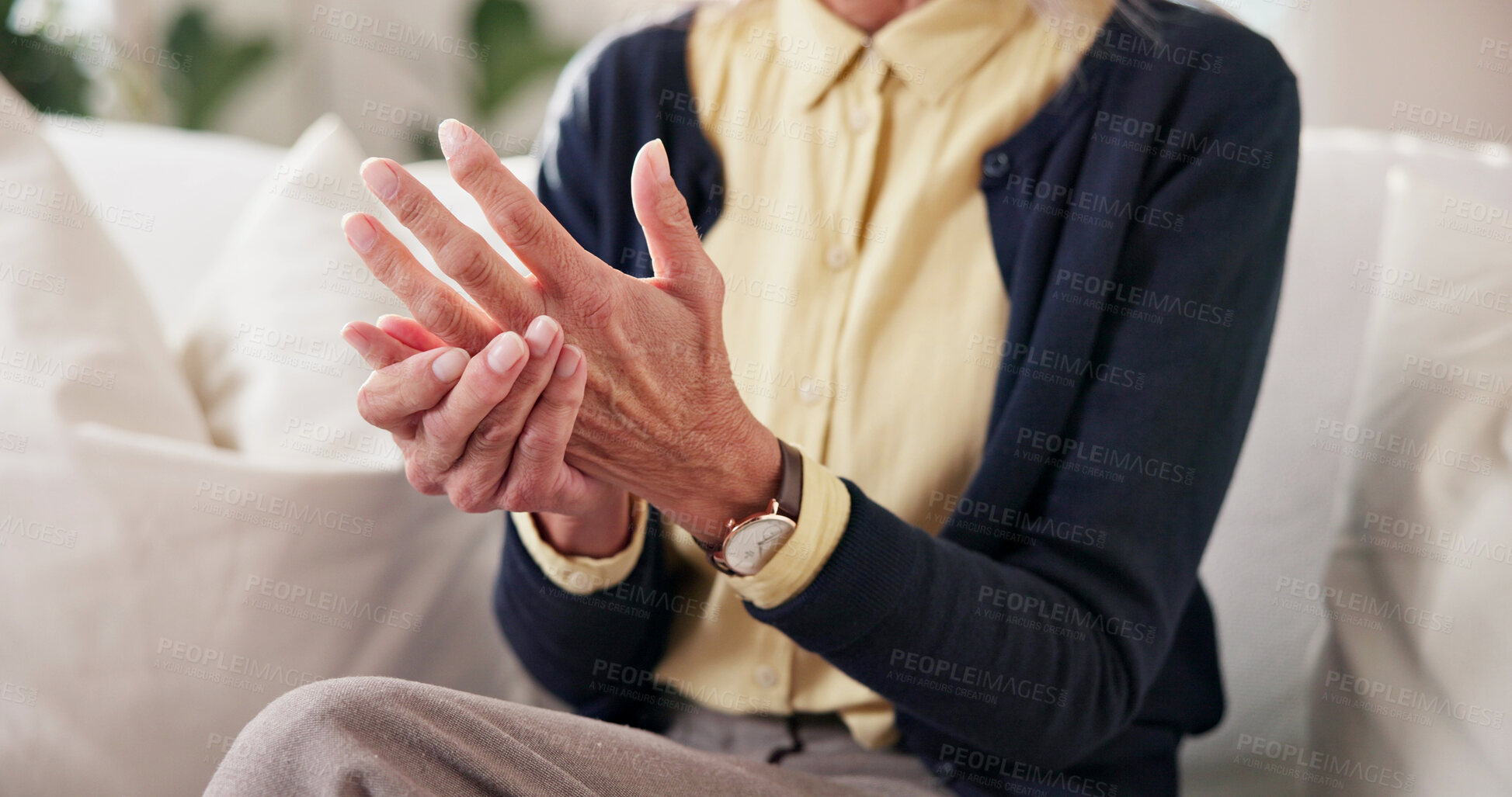 Buy stock photo Home, hands and senior person with joint pain for arthritis inflammation, chronic illness or massage. Retirement, pensioner and finger stiffness on sofa with discomfort, rheumatism risk and grip loss