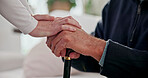 Hands, caregiver and comfort old person with walking stick, support and empathy for recovery. Nurse, console or senior patient with disability, assisted living and sympathy for rehabilitation in home