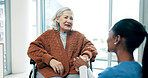 Clinic, caregiver and holding hands with old woman in wheelchair, support or helping elderly patient. Nurse, consultation and senior person with disability, happy and healthcare services in hospital