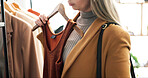 Hand, clothes and woman in store, choice and shopping with retail therapy, options and fashion. Customer, luxury design and person in boutique, discount deal and sale for product and inspection
