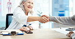 Handshake, greeting and doctor with woman in hospital for agreement in medical consultation. Appointment, welcome and healthcare worker shaking hands with patient for thank you at checkup in clinic.