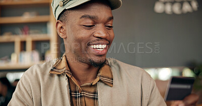 Buy stock photo Black man, smile and credit card for payment in coffee shop, finance or investment with purchase. Password, reading details or person check account number for transaction, paying or buying in cafe