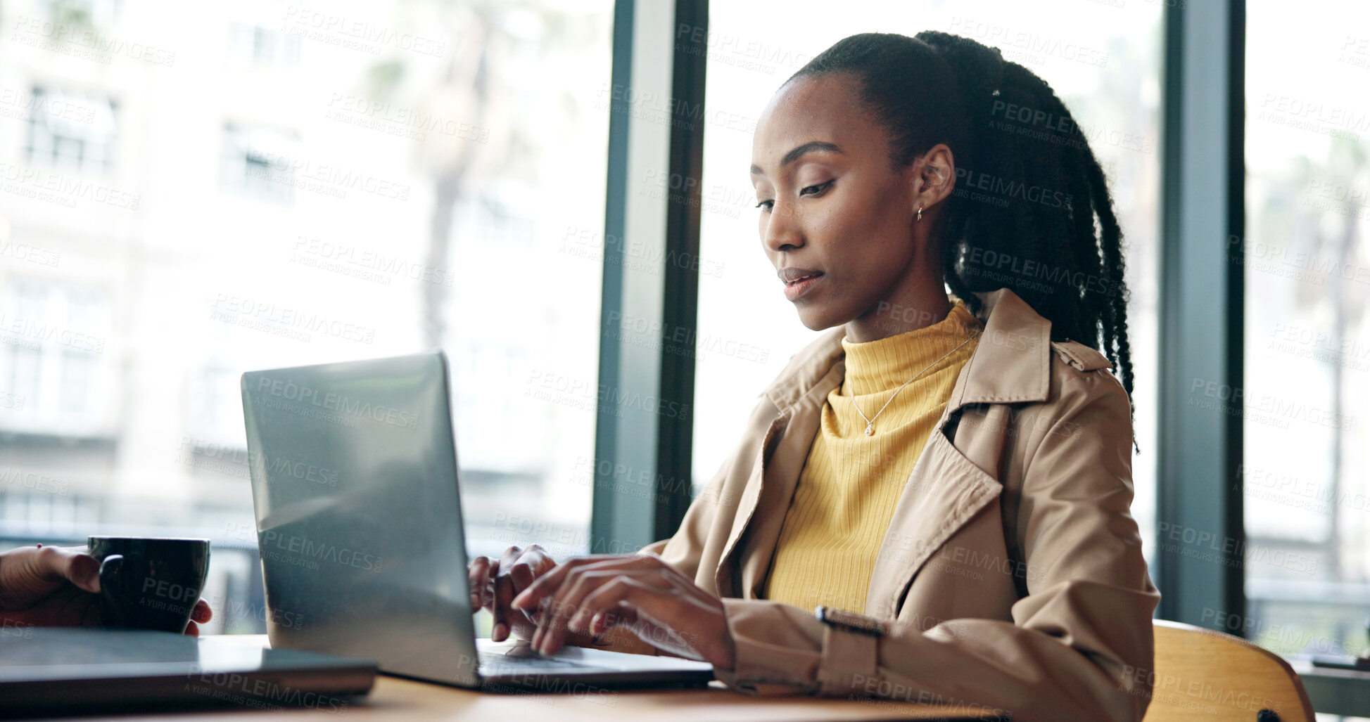 Buy stock photo Laptop, typing and black woman in coffee shop for research on creative project with freelance career. Computer, reading and African female magazine editor with online article for publishing in cafe.
