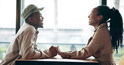 Buy stock photo Couple, laugh and holding hands at cafe on date, love and affection for bonding together. Funny, black people and talk at coffee shop with romance, healthy relationship and connection for commitment