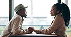 Happy, couple and holding hands at cafe on date, love and affection for bonding together. Smile, black people and talk at coffee shop with romance, healthy relationship and connection for commitment