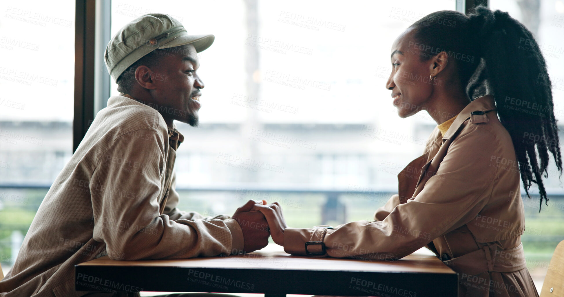 Buy stock photo Smile, couple and holding hands at cafe on date, love and affection for bonding together. Happy, black people and talk at coffee shop with romance, healthy relationship and connection for commitment