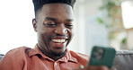 Laugh, phone and black man on sofa in home with networking, connection or texting on mobile app. Relax, technology and African male person with cellphone for chatting, communication or social media.