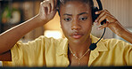 Woman, headset and remote work at night with laptop, customer service and agent for crm. African person, freelancer and working late with pc, assistance and telecom representative for inquiry in home