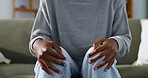 Anxiety, sofa and hands of woman on knees for trauma response, doubt and worry for mental health. Therapy, anxious and person with nervous, overwhelmed and unsure for decision, future or overthinking