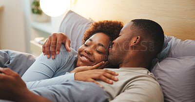Buy stock photo Kiss, love and relax with black couple in bed at apartment together for bonding, connection or rest. Affection, morning and wake up with happy people in bedroom of home for break, holiday or romance