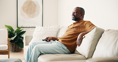 Buy stock photo Happy, relax and black man watching tv on sofa for entertainment or online subscription in home. Male person, chilling and smile with remote on couch for movie, series or streaming app in house