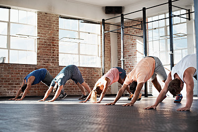 Buy stock photo Shot of a group of people stretching in a fitness class
