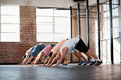 Buy stock photo Shot of a group of people stretching in a fitness class