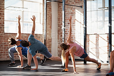 Buy stock photo Shot of a group of people doing some strength training in a fitness class