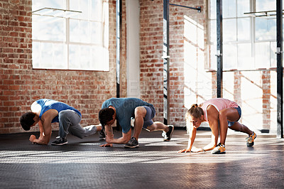 Buy stock photo Shot of a group of people doing a fitness class