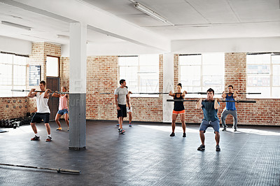 Buy stock photo Shot of a group of people doing a fitness workout with bars