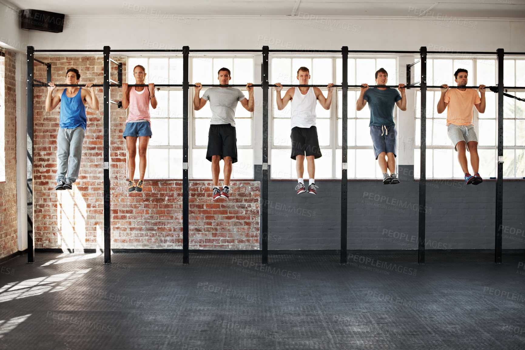Buy stock photo Gym, people and fitness group with chin up exercise, training and wellness in class together. Men, women and serious at facility for workout, development and body health with metal bar for resilience