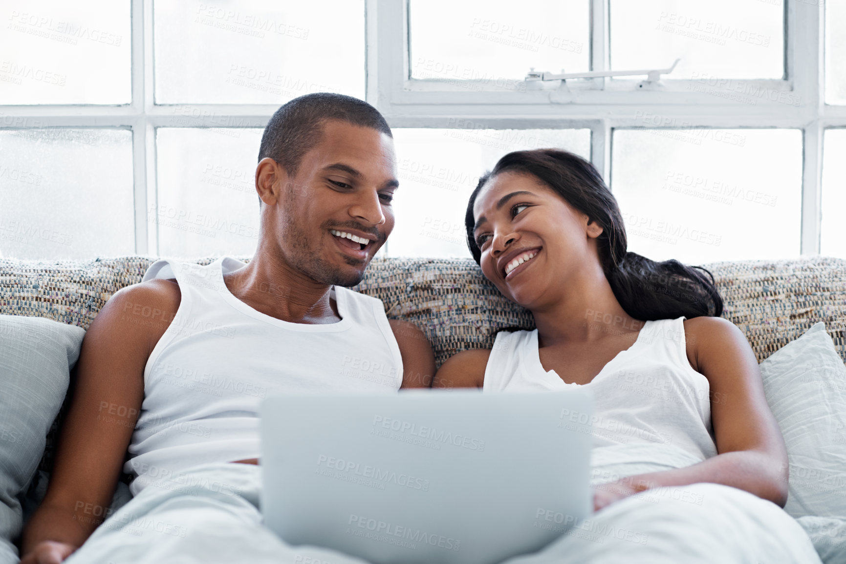 Buy stock photo Cropped shot of a young couple enjoying their morning at home